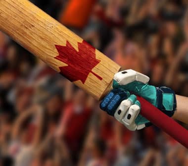 A batsman wearing cricket gloves and holding a cricket bat with a maple leaf on it.