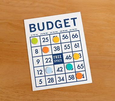 Bingo card, reading BUDGET, on table.